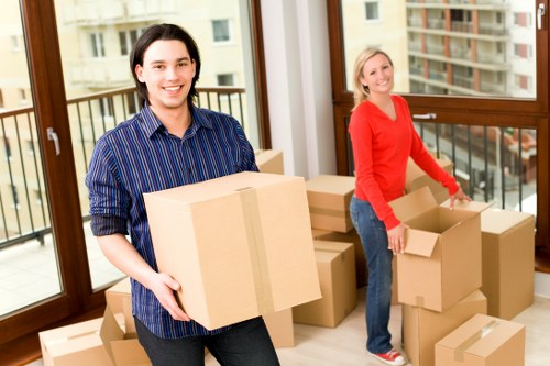 Professional movers packing fragile belongings for transport