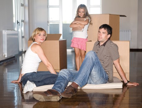 Moving team loading boxes and furniture into a removals van in Belgravia
